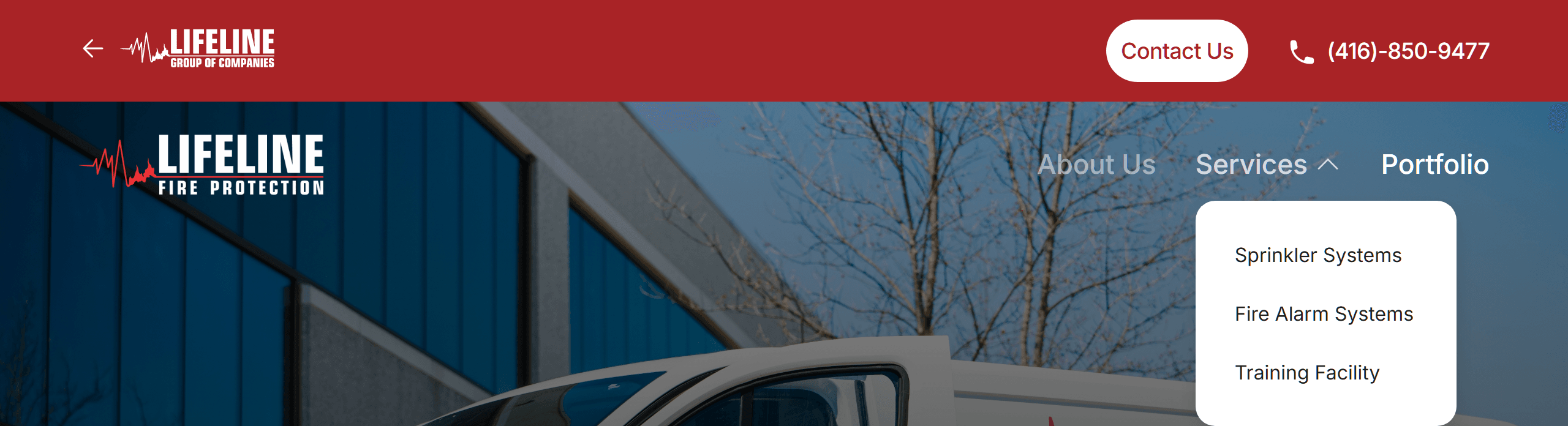 The live Fire Protection page header. The red top bar holds a back arrow and the small Lifeline Group of Companies logo, Contact Us and a phone number. Below, the Lifeline Fire Protection logo sits on the left and its own menu on the right: About Us, Services with its dropdown open showing Sprinkler Systems, Fire Alarm Systems and Training Facility, and Portfolio.